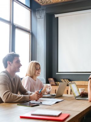 three-young-happy-colleagues-coworking